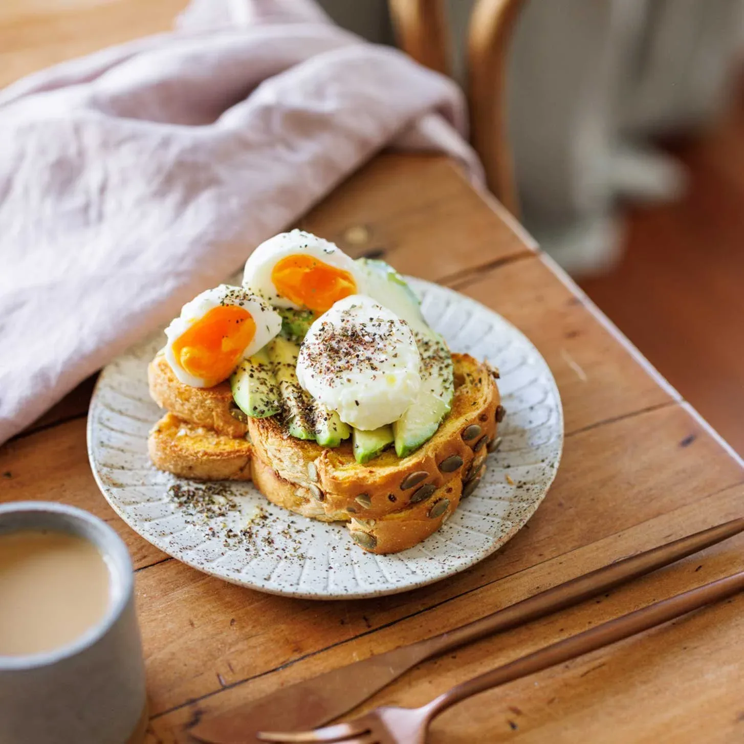 Poached eggs and sliced avocado on toast, sprinkled with Mette is Baking Scandi Summer Nordic Dip Mix