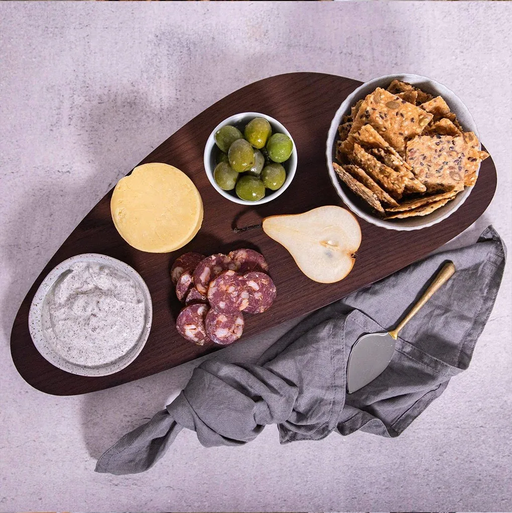 A winter inspired grazing board for a cosy night around the firepit, including cheese, olives, pear, cured meats, dip and Mette is Baking dip mix