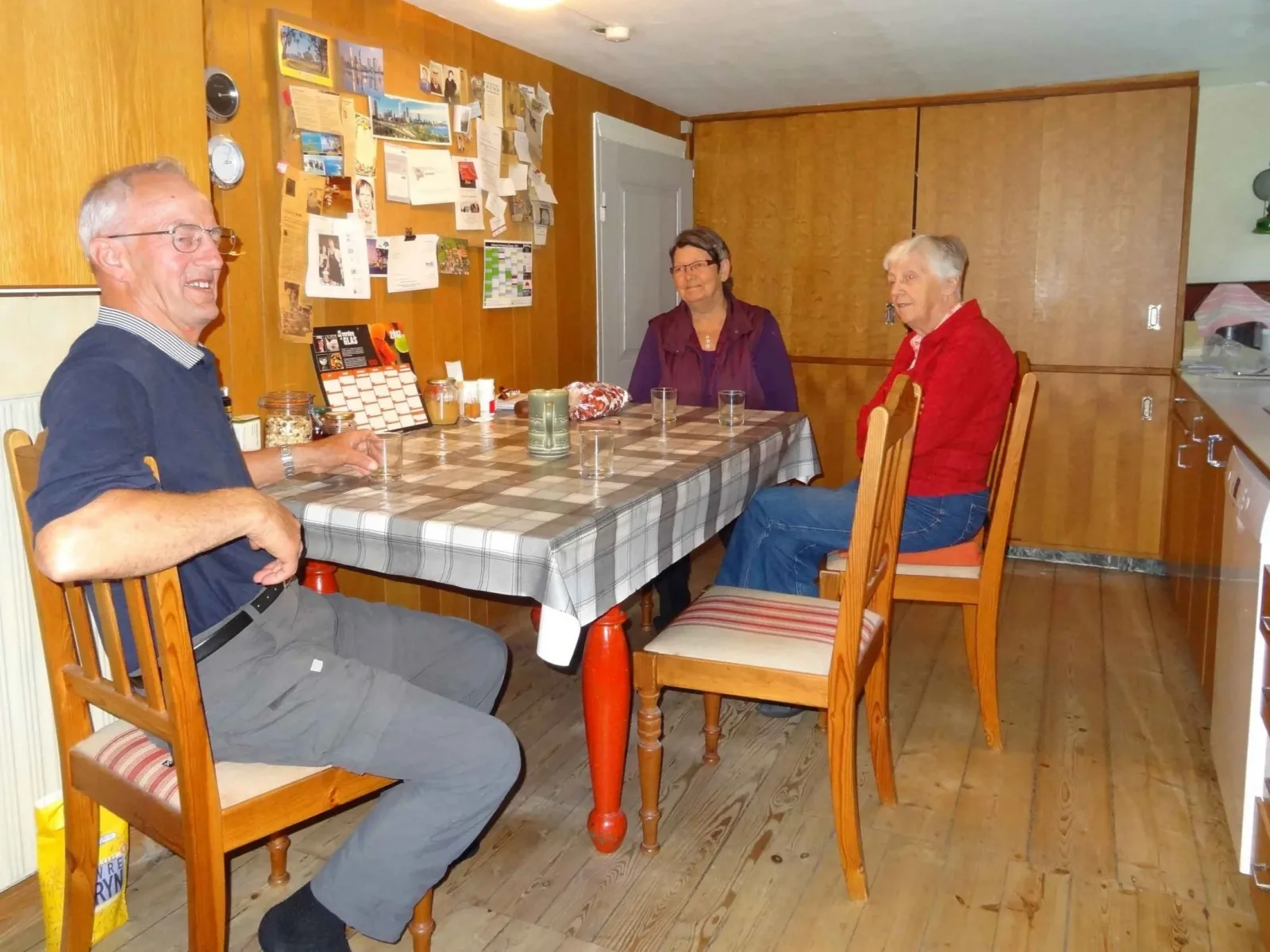 Mette’s parents and cousin sharing a meal together at the family home